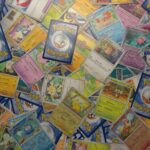 Trading cards spread on a table for calculating resale profit