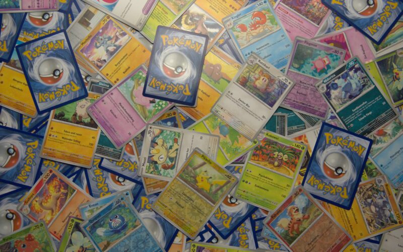 Trading cards spread on a table for calculating resale profit
